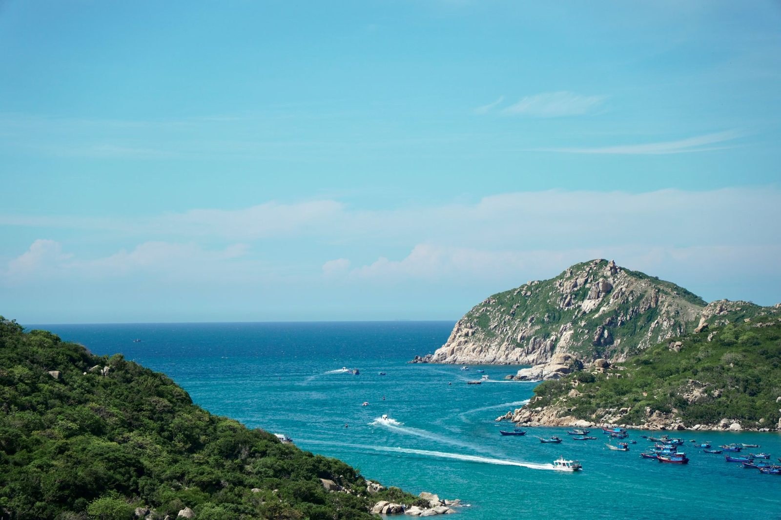 Fishing boats anchored in a turquoise bay off the central Vietnam coast