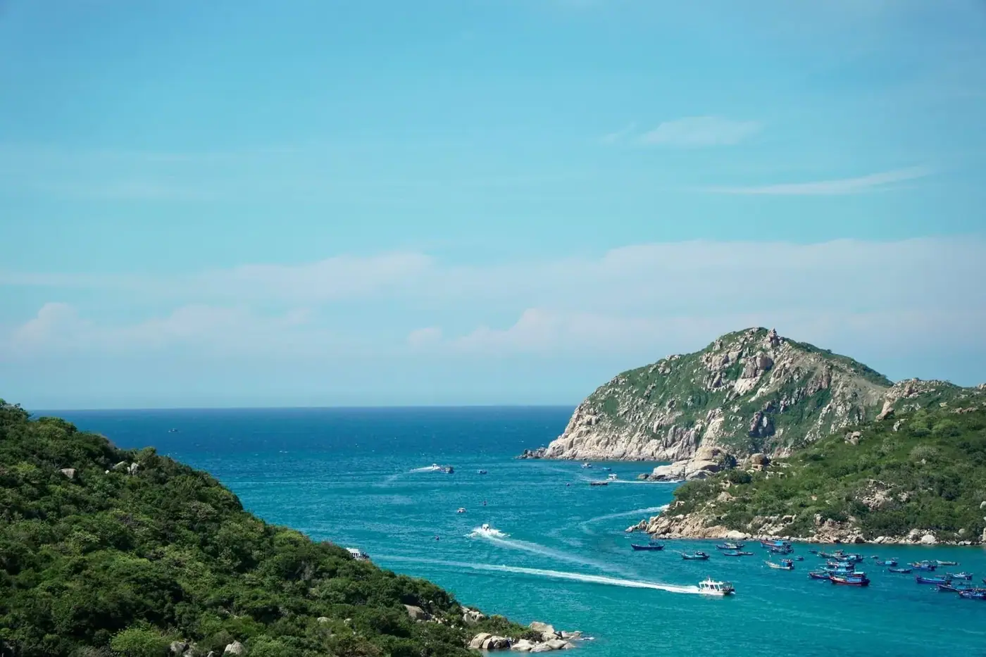 Fishing boats anchored in a turquoise bay off the central Vietnam coast