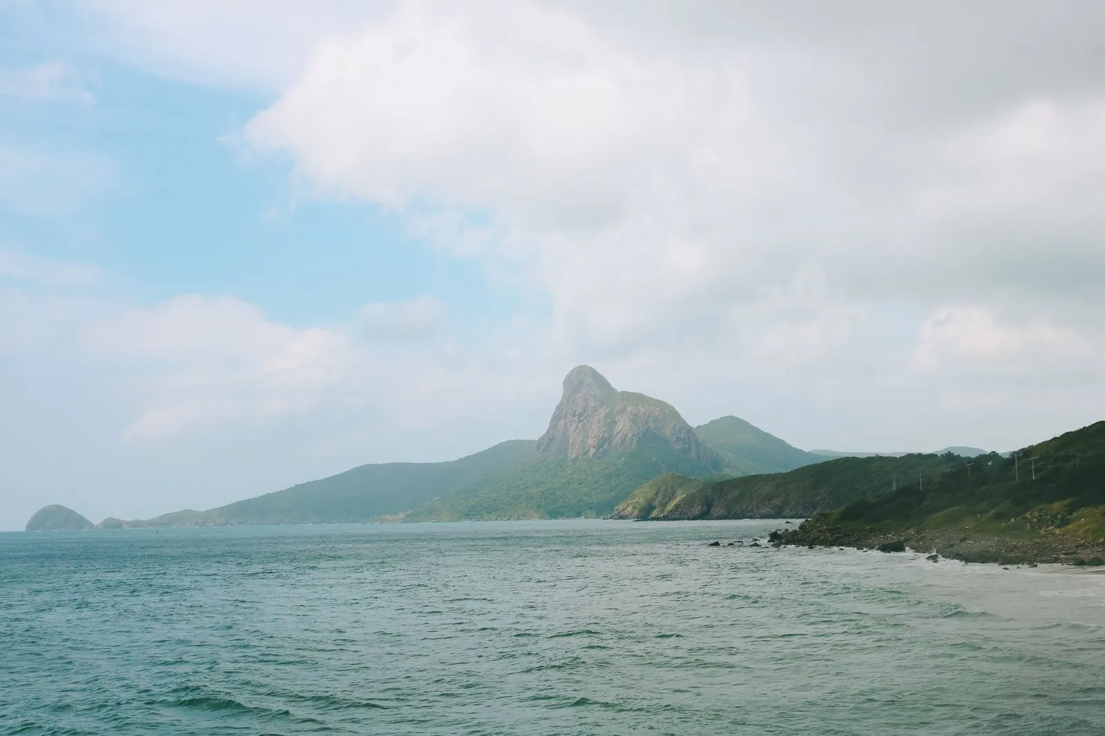 Con Dao’s peaked mountain seen from a rocky beach