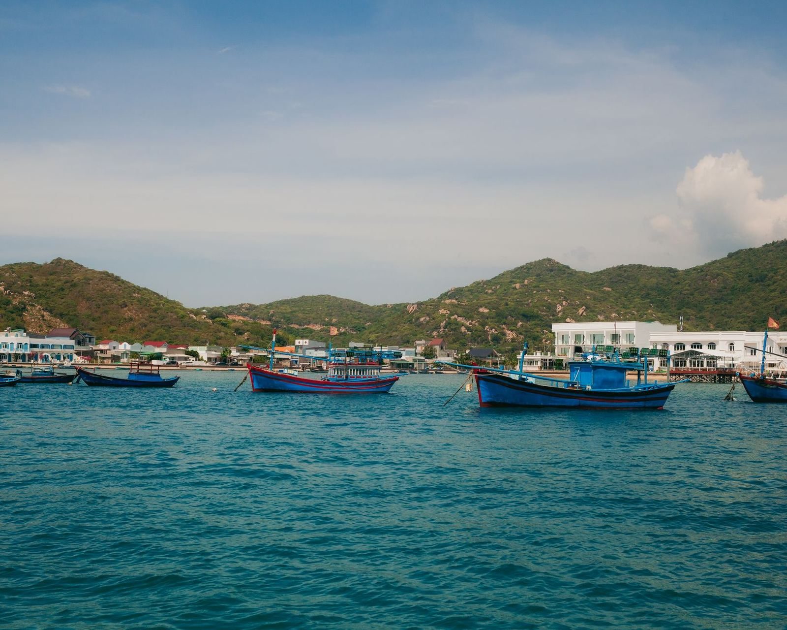 Fishing boats moored along a coastal village near Hoi An