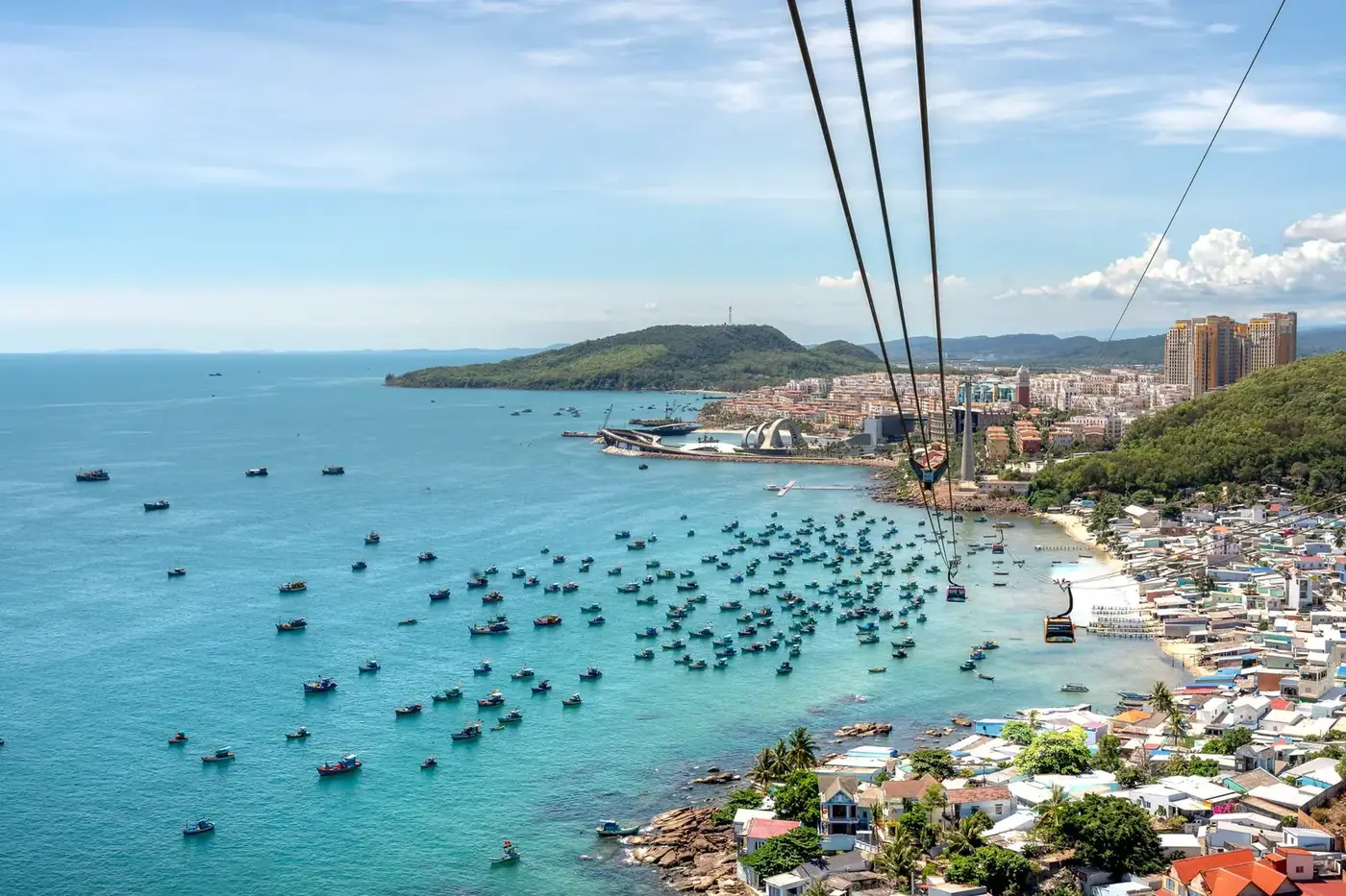 Aerial view of the Hon Thom cable car crossing Phu Quoc’s harbor and fishing boats