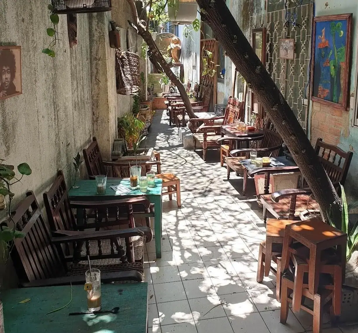 A quiet riverside cafe alley with outdoor tables in Da Nang