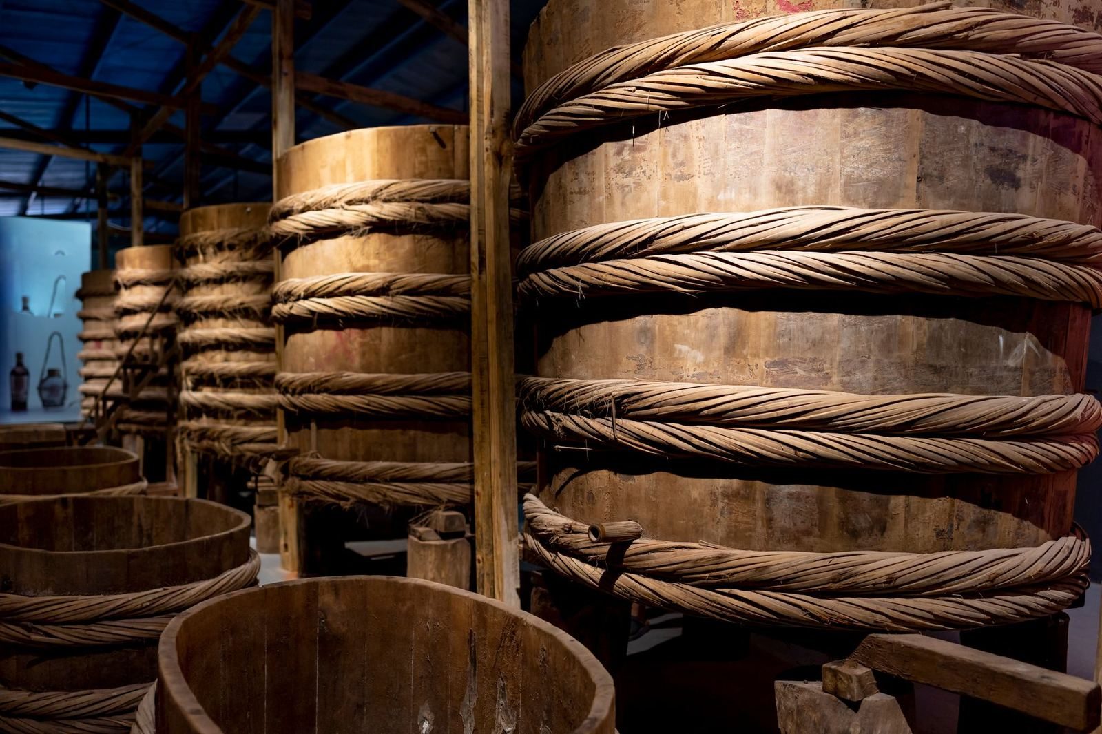 Rows of large wooden barrels used to ferment traditional fish sauce
