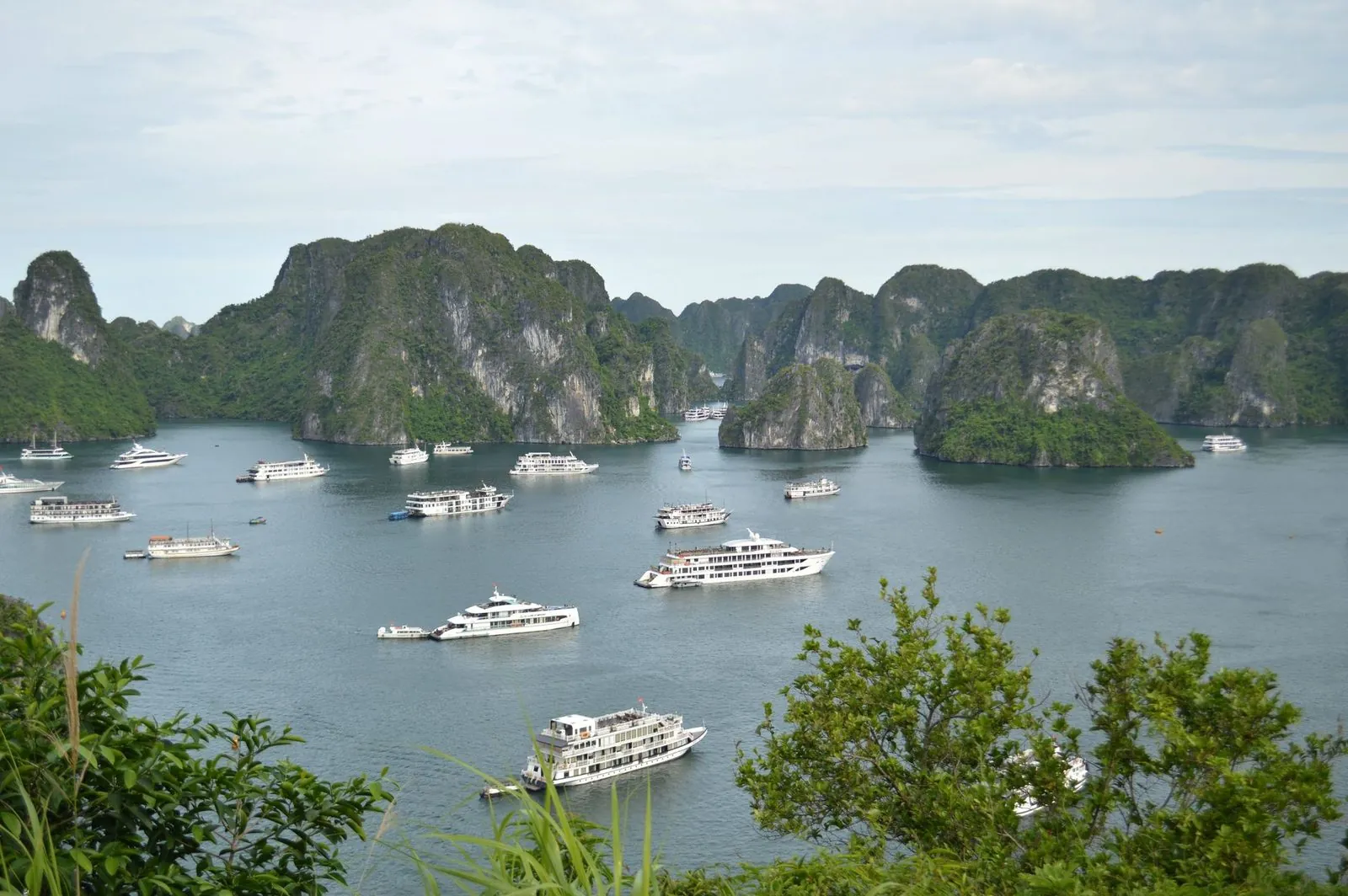 Cruise boats among the limestone karsts of Ha Long Bay in Vietnam