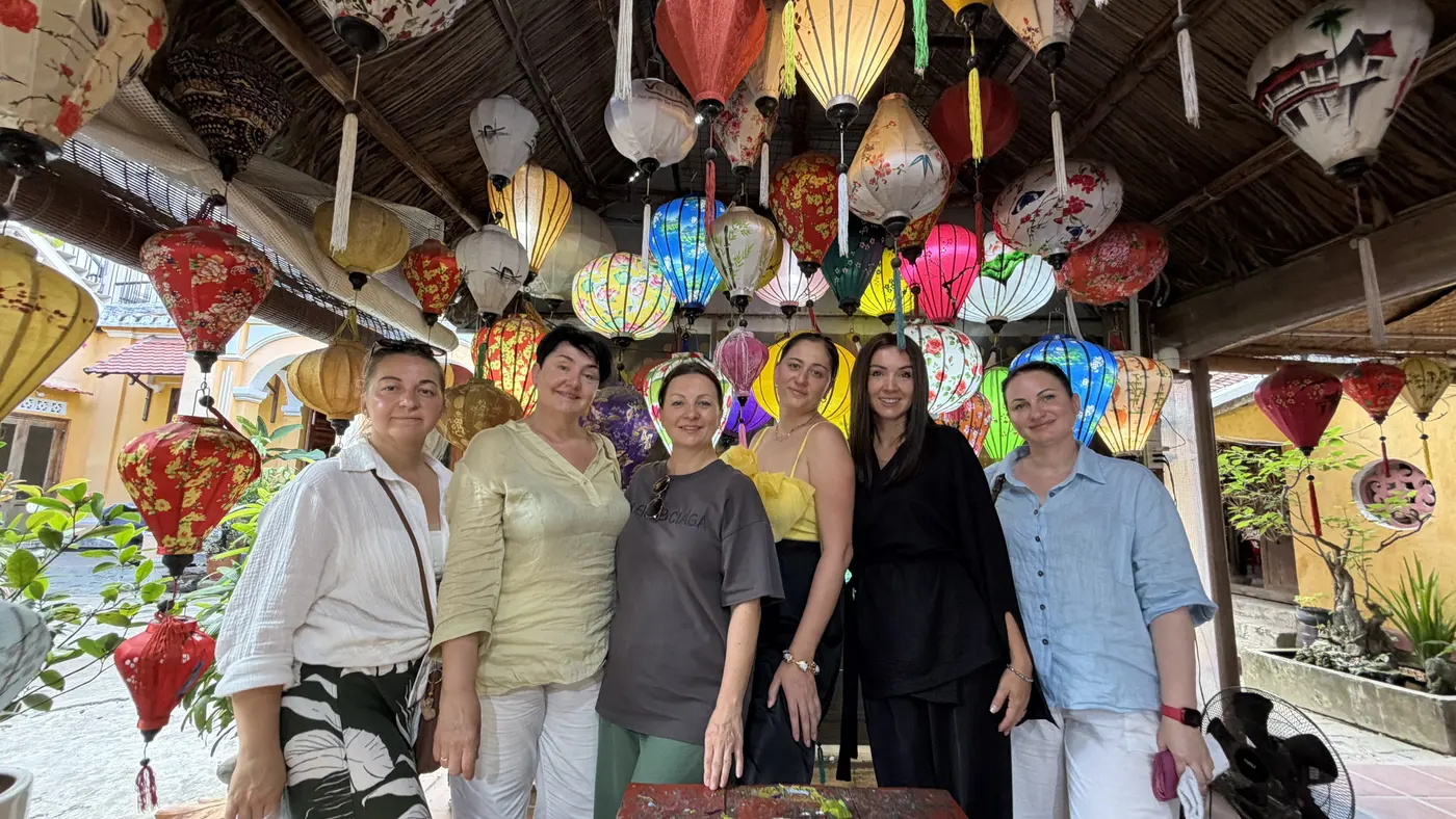 Tour group among silk lanterns in a Hoi An workshop