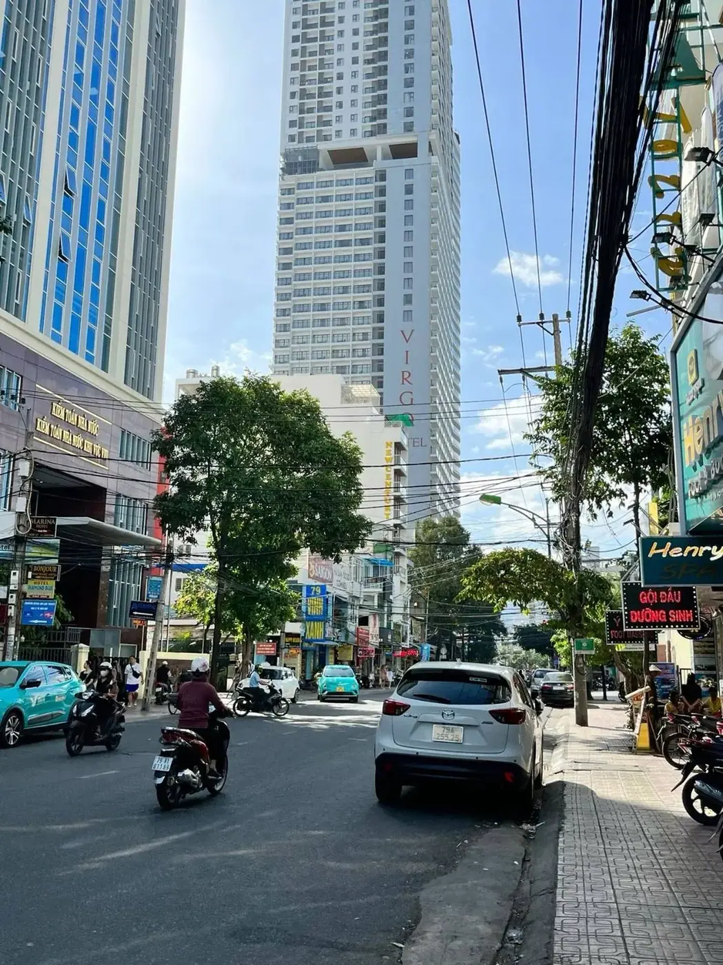 Street in central Nha Trang with hotels and motorbikes