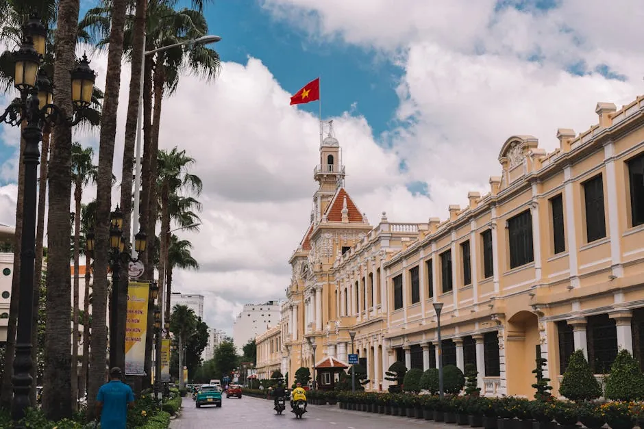 Ho Chi Minh City — the People’s Committee building with a Vietnamese flag, Le Loi Boulevard