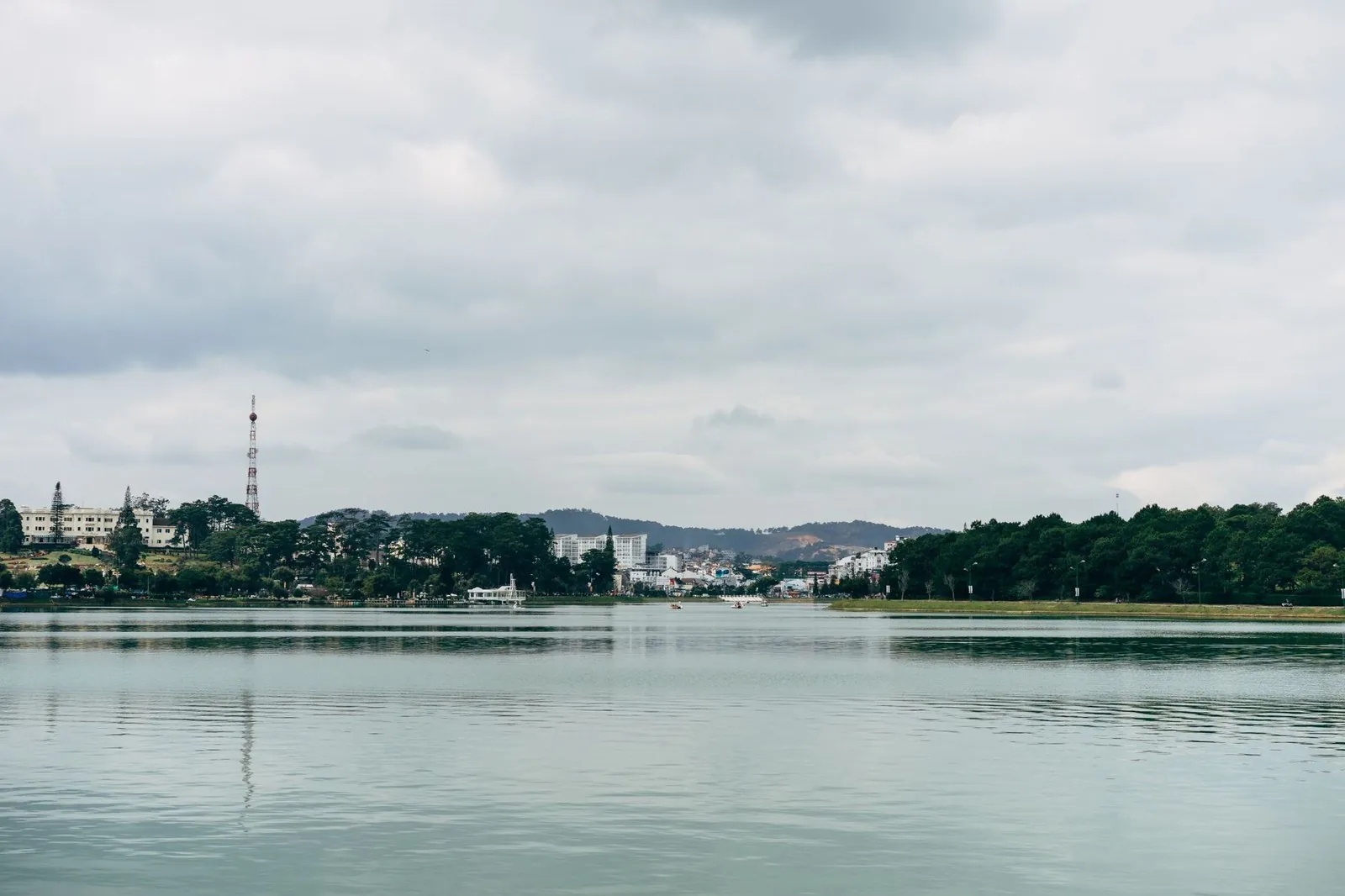 Xuan Huong Lake in Da Lat with the city skyline reflected on a cloudy day