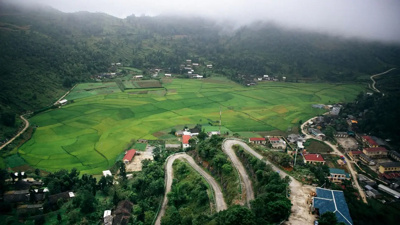 Aerial view of a winding road through green countryside in central Vietnam