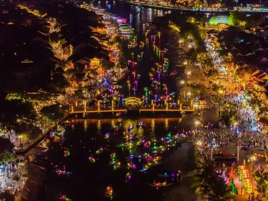 Hoi An old town and the Hoai River with floating lanterns seen from above at night