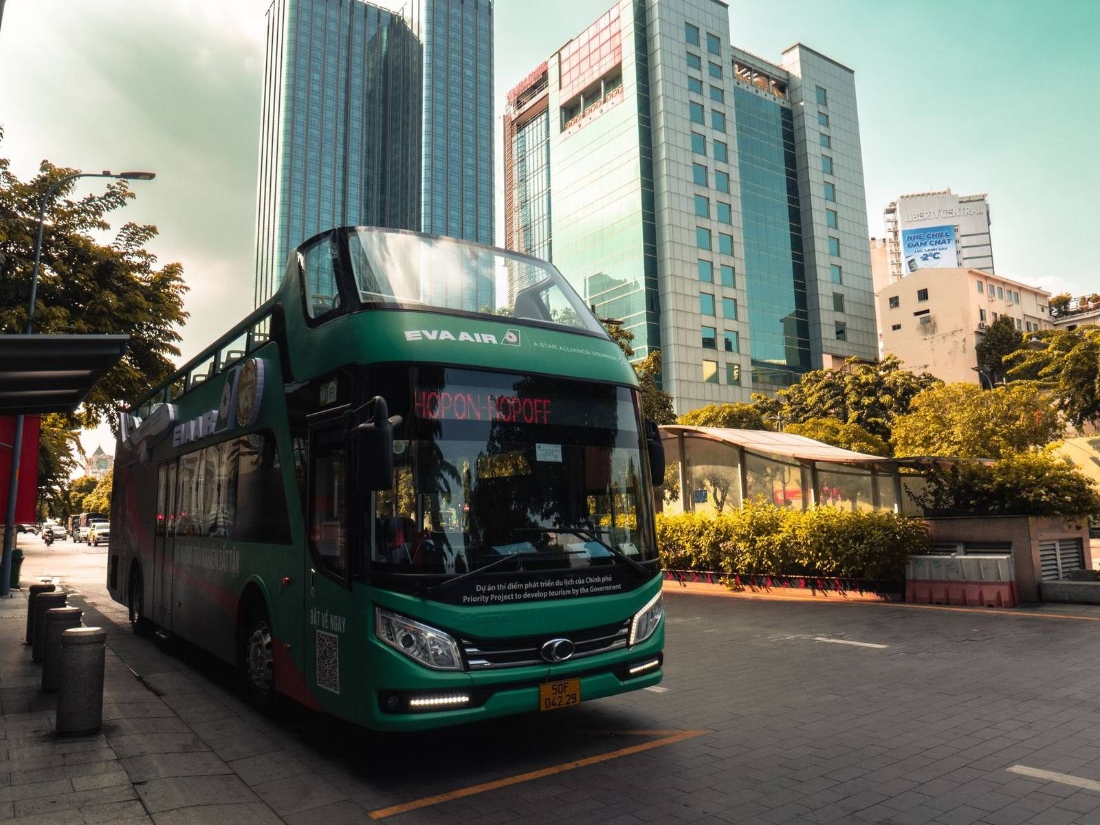 A bus on a busy Ho Chi Minh City street lined with high-rises