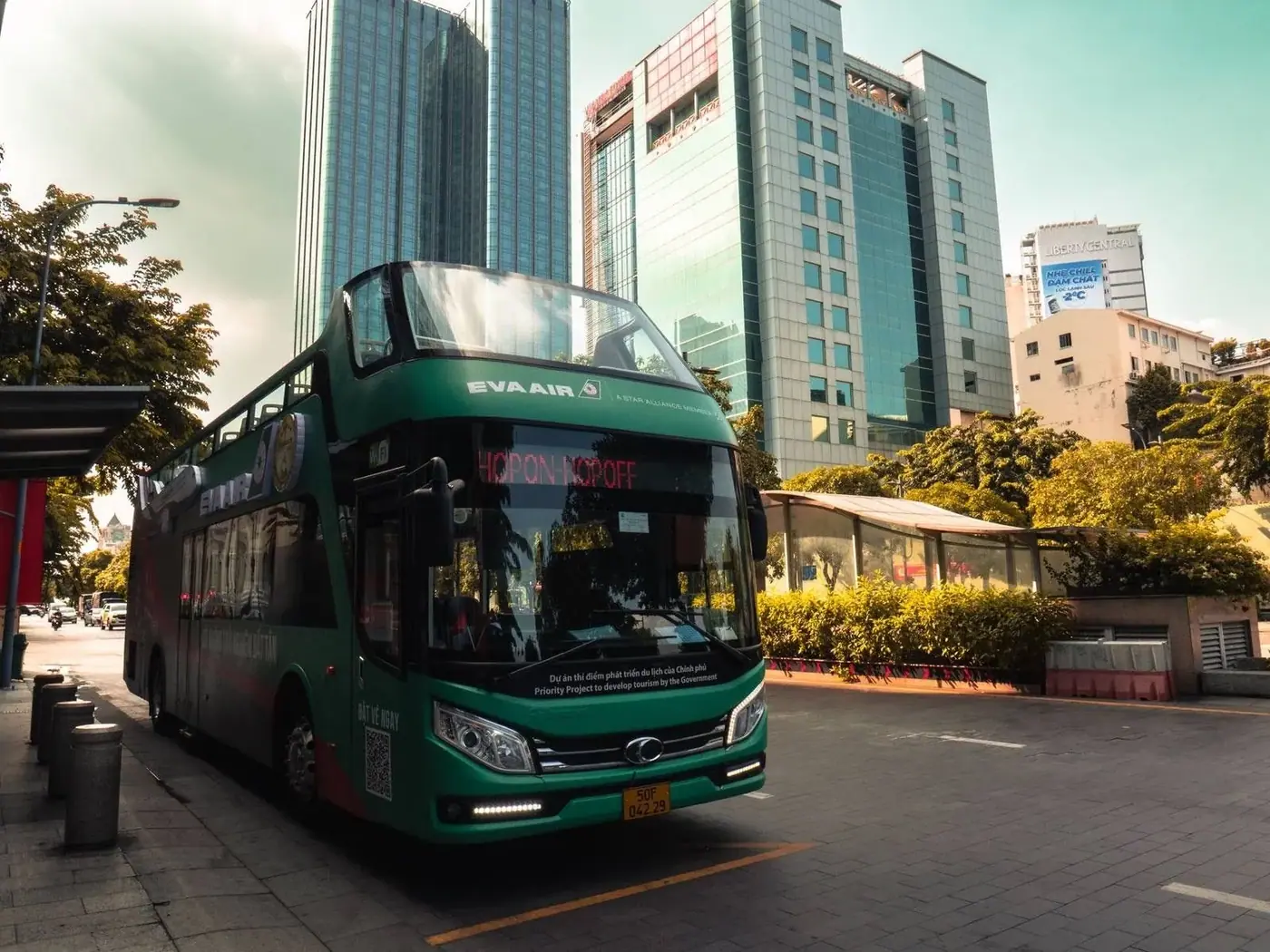 A bus on a busy Ho Chi Minh City street lined with high-rises