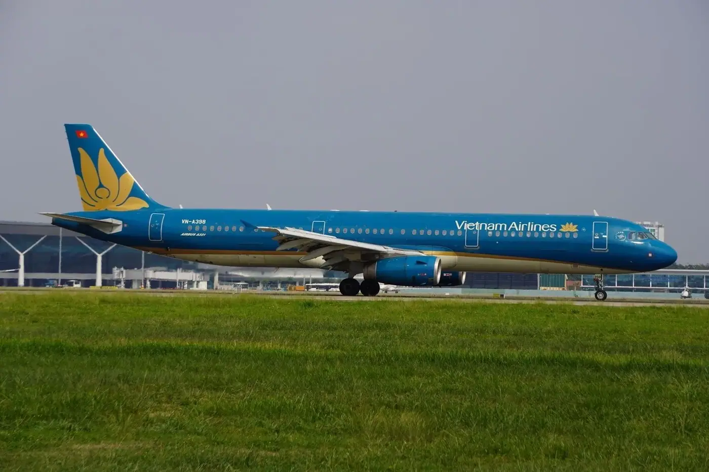 Vietnam Airlines jet taxiing on a domestic runway in Vietnam