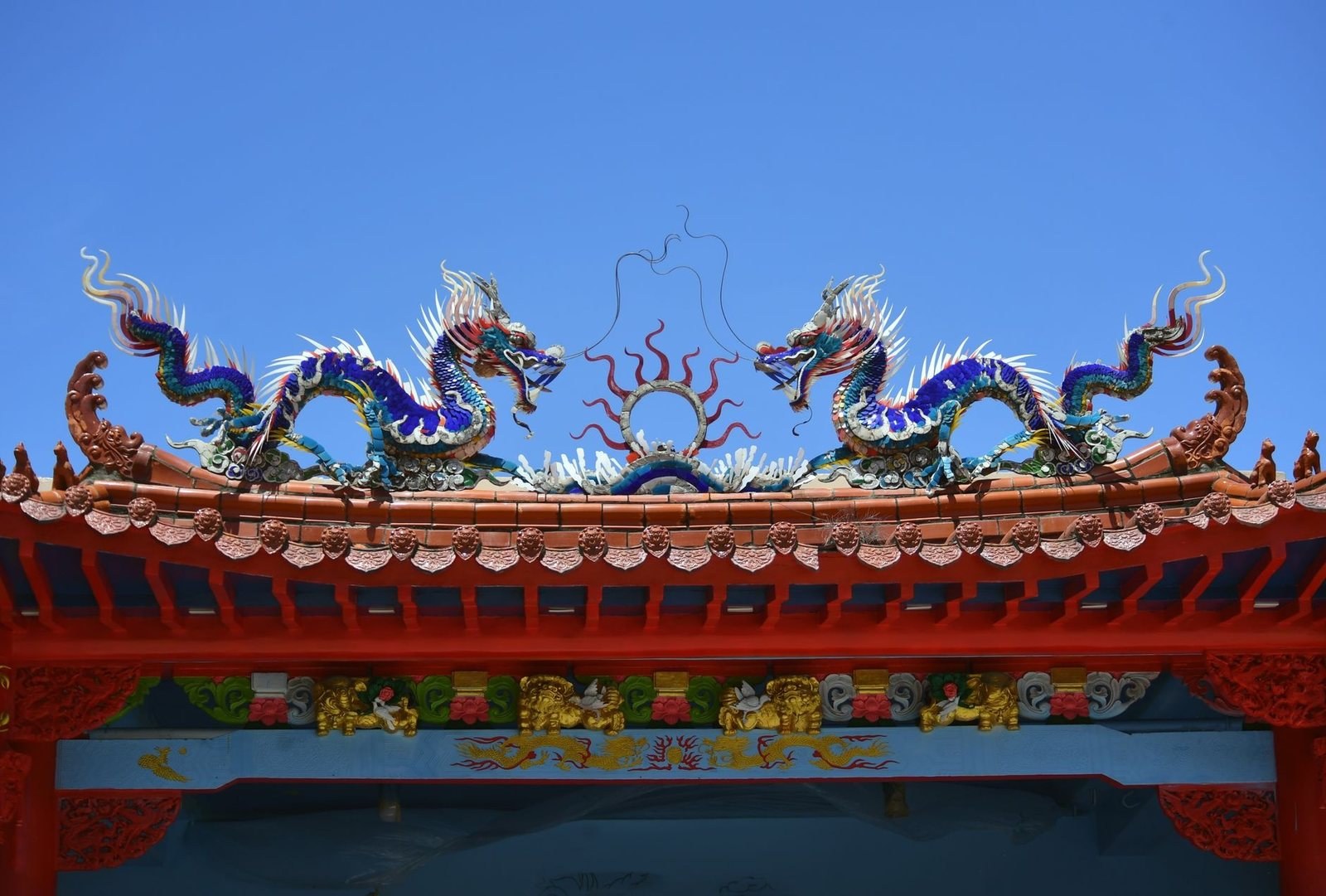 a ceramic mosaic dragon decorating a Vietnamese temple roof