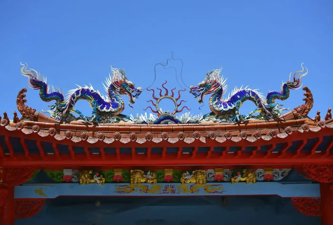 a ceramic mosaic dragon decorating a Vietnamese temple roof