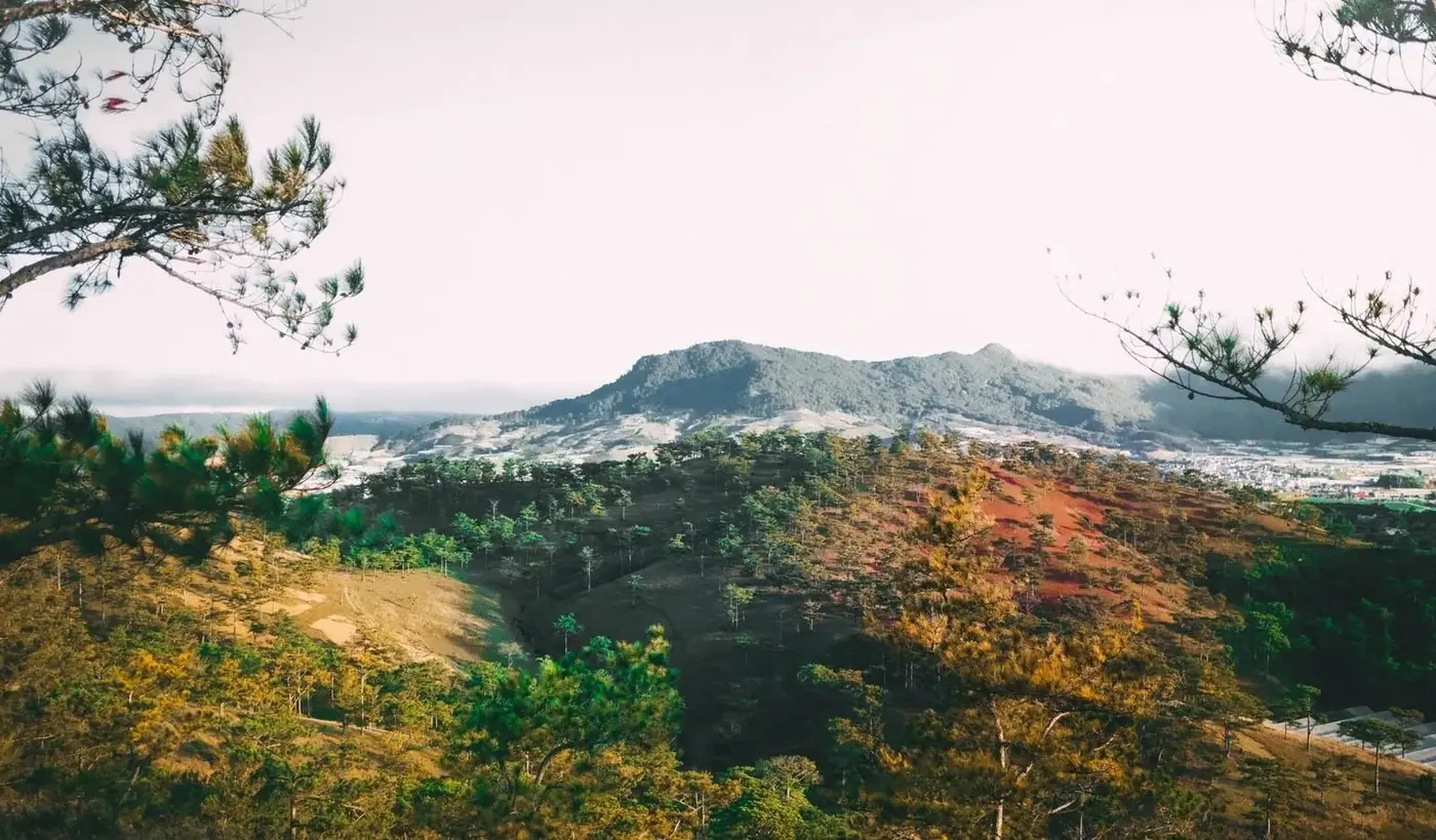 a mountain peak rising above forested hills near Dalat