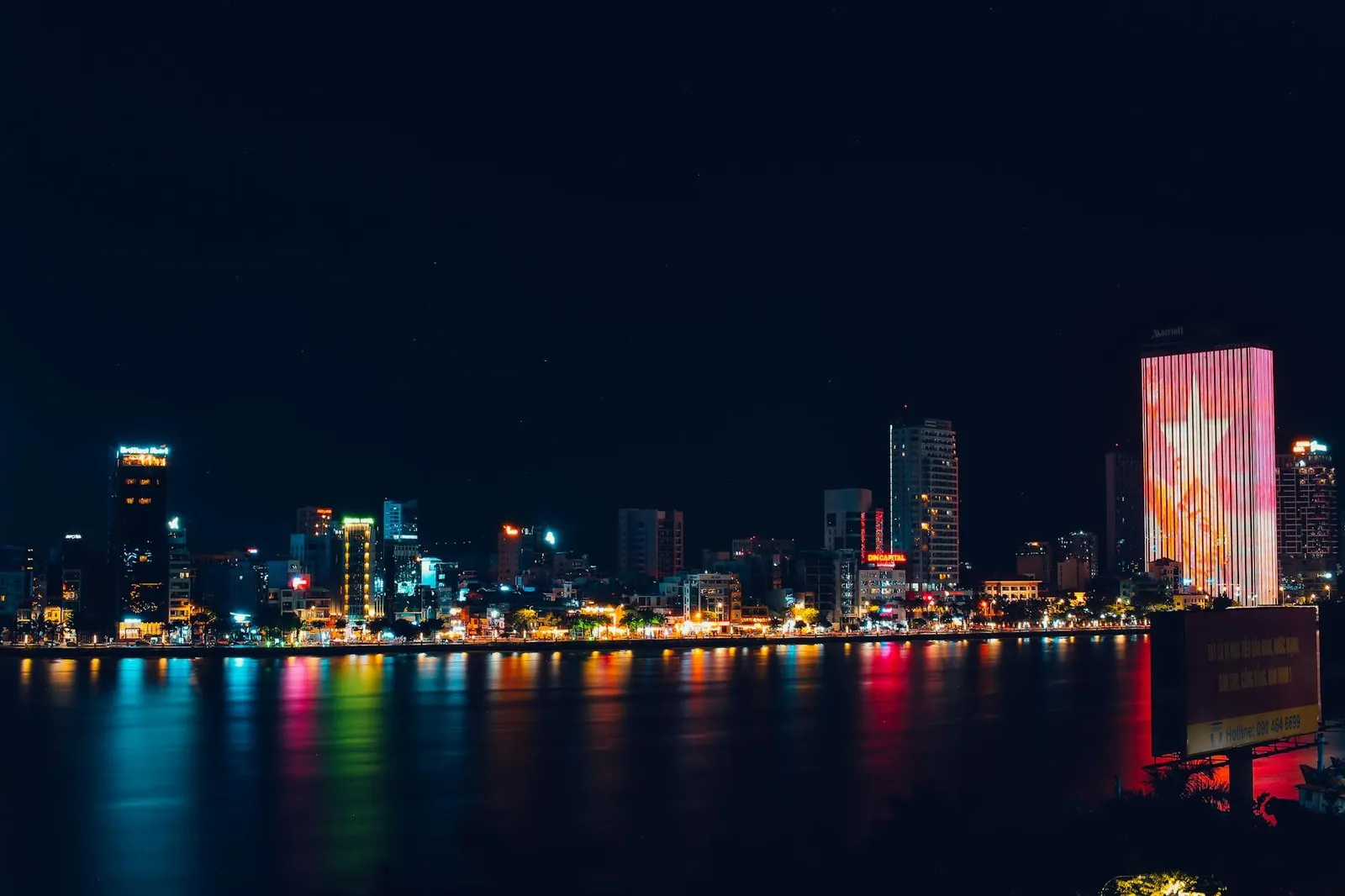 Da Nang night skyline with city lights reflected in the Han River