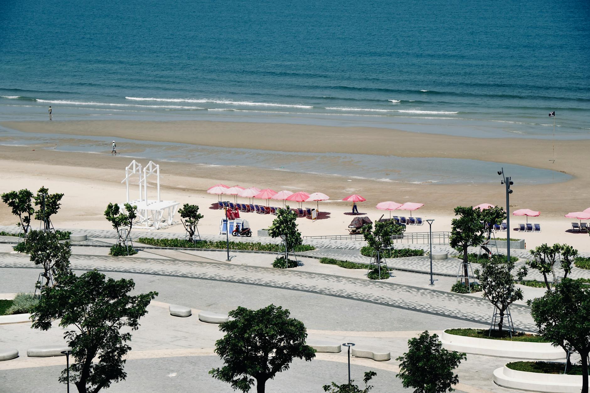 Da Nang beachfront promenade with pink umbrellas, view from above