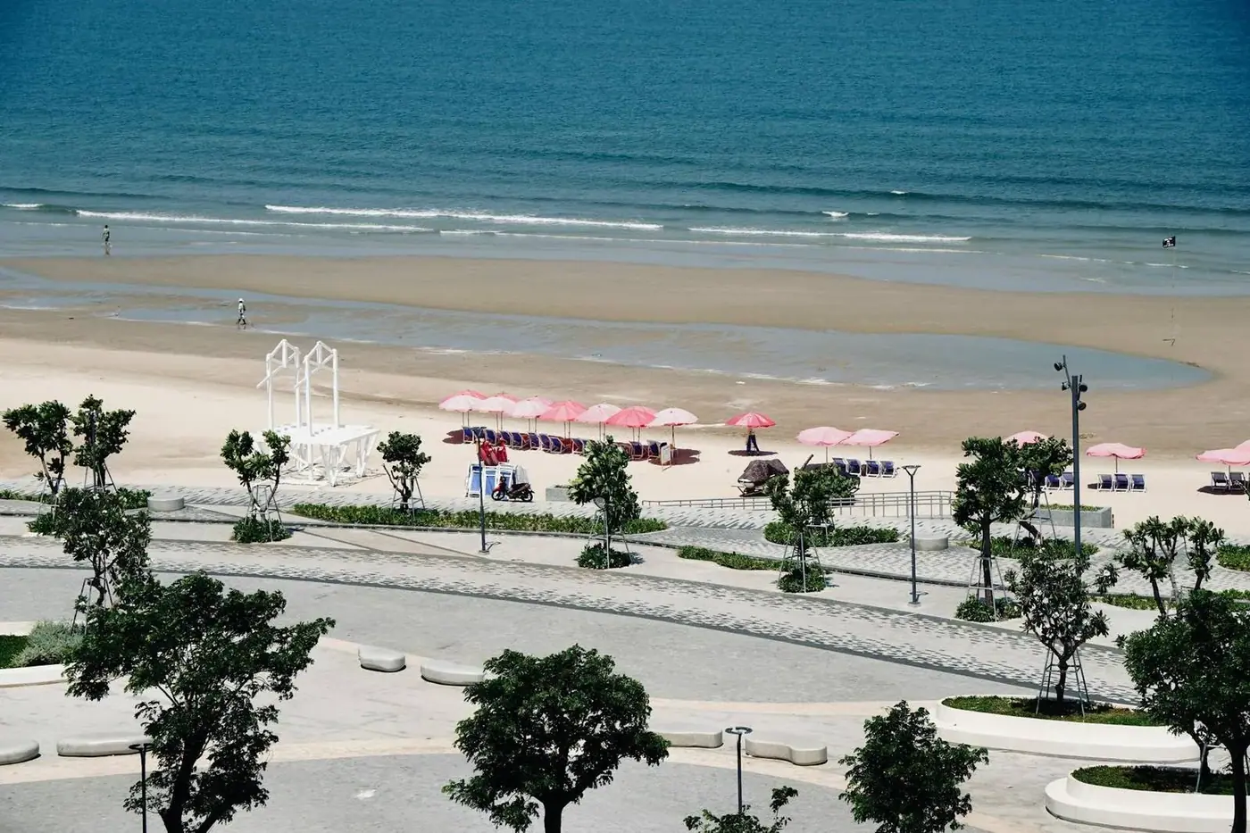 Da Nang beachfront promenade with pink umbrellas, view from above