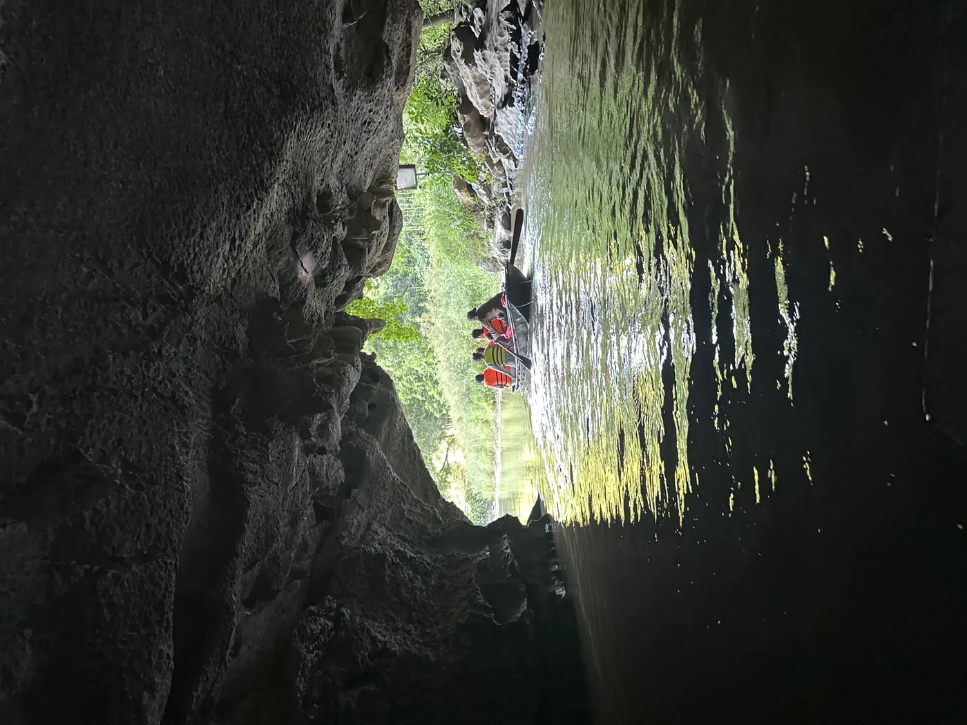 Boat emerging from a cave tunnel during a Vietnam scouting trip