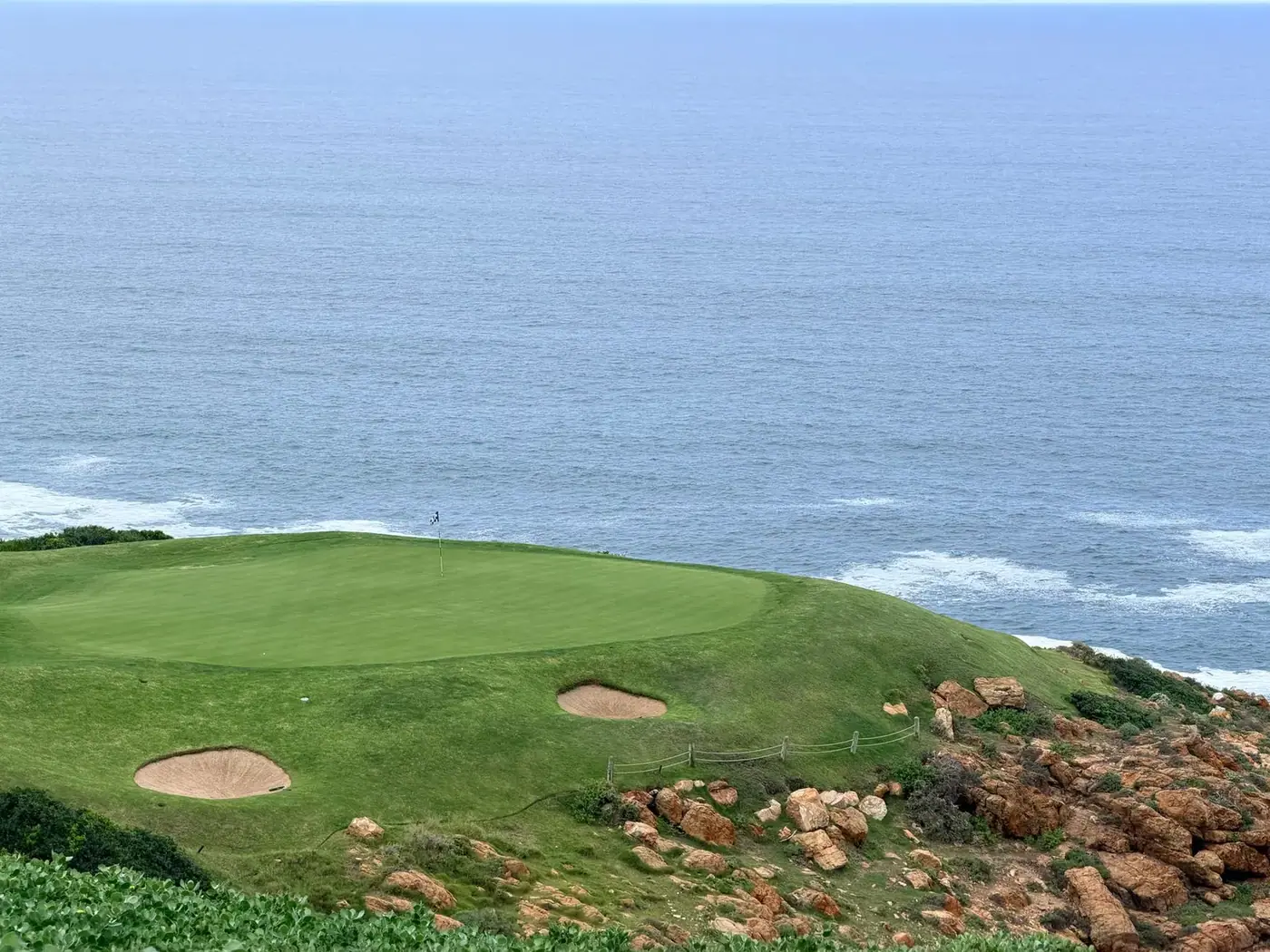 Golf course fairway with sand bunkers and an ocean view