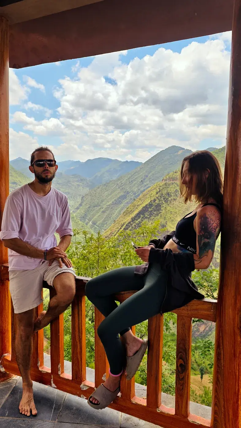 Two travelers pausing on a mountain overlook route in northern Vietnam