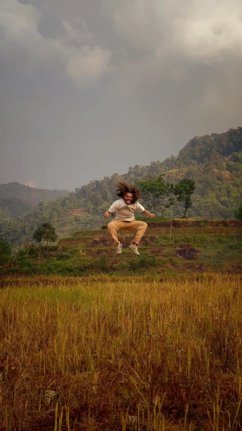 Traveler jumping in a rice field in the northern Vietnam highlands