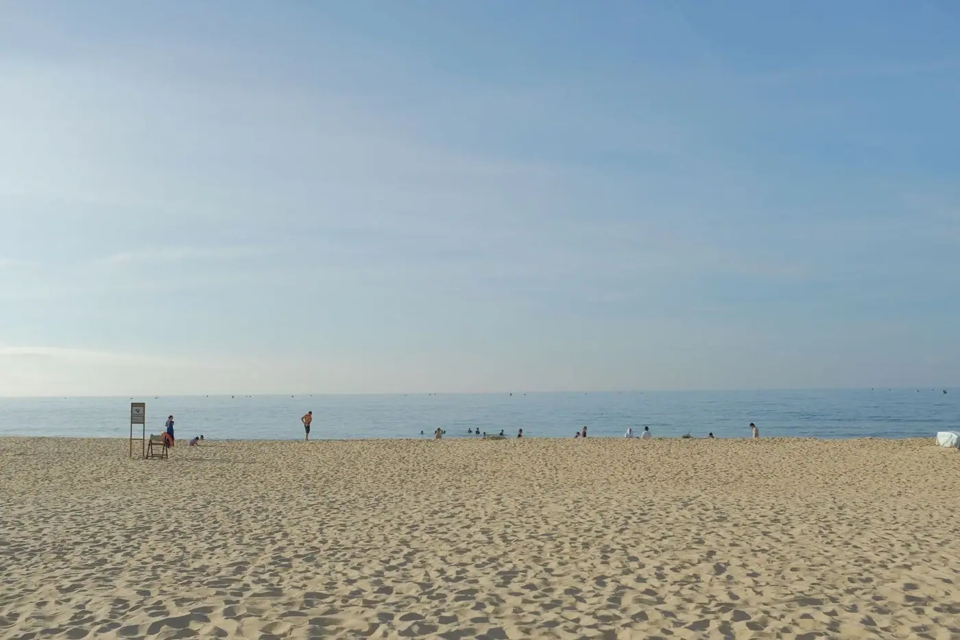 Quiet sandy beach near Hoi An with calm turquoise water