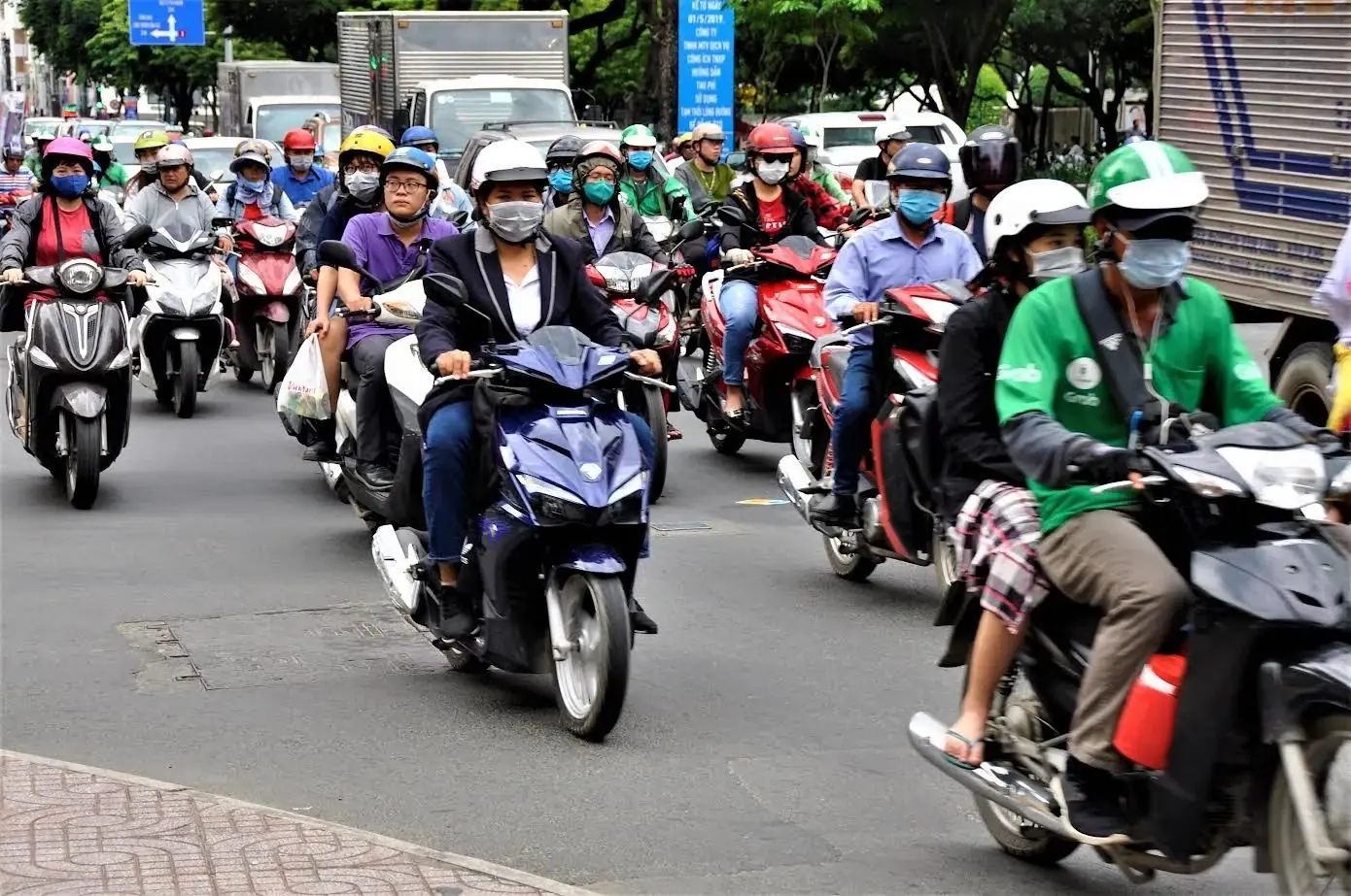 Dense motorbike traffic on a street in Ho Chi Minh City during rush hour