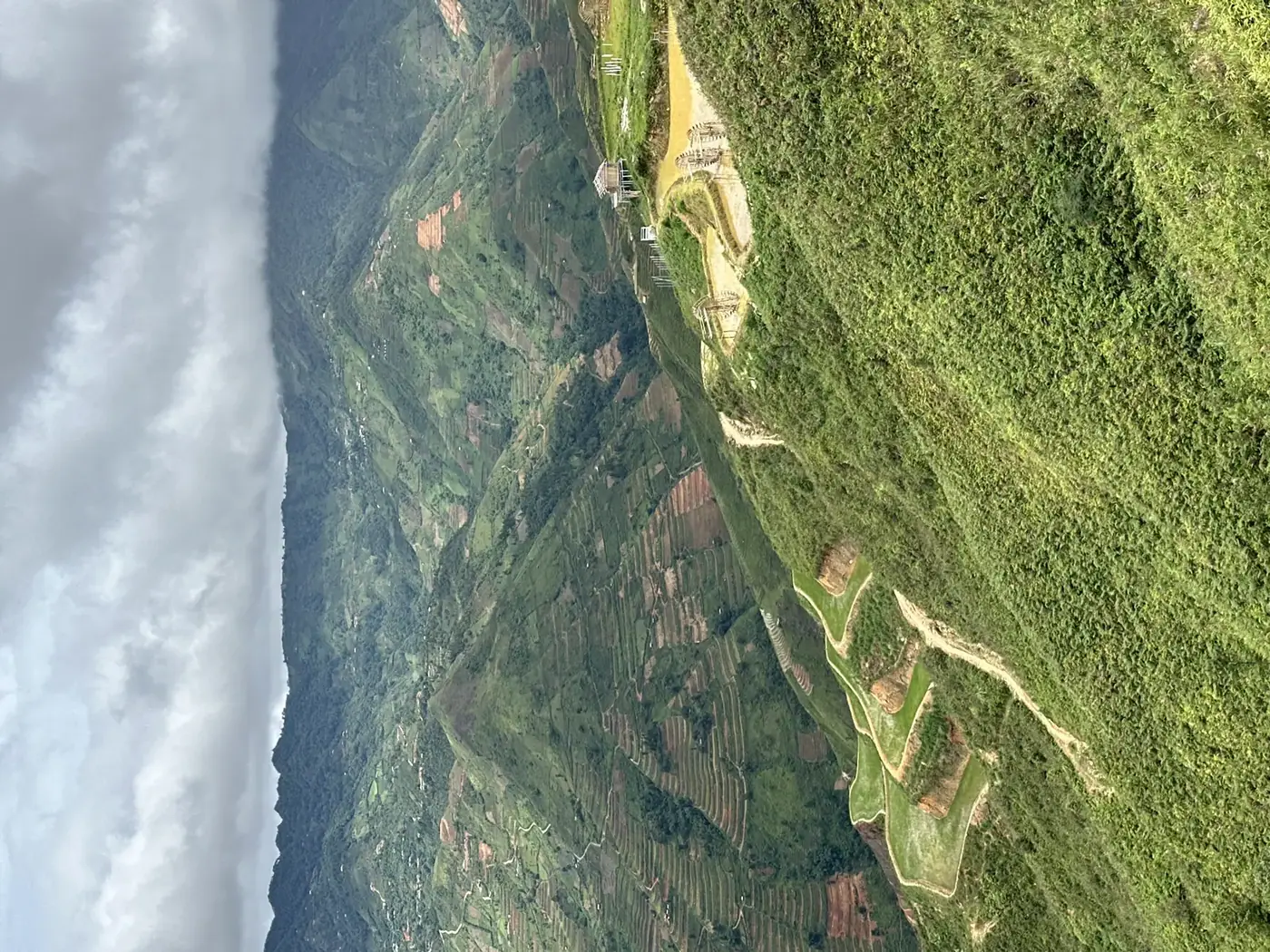Aerial view of layered rice terraces and a farming village in the Sapa or Ha Giang mountains