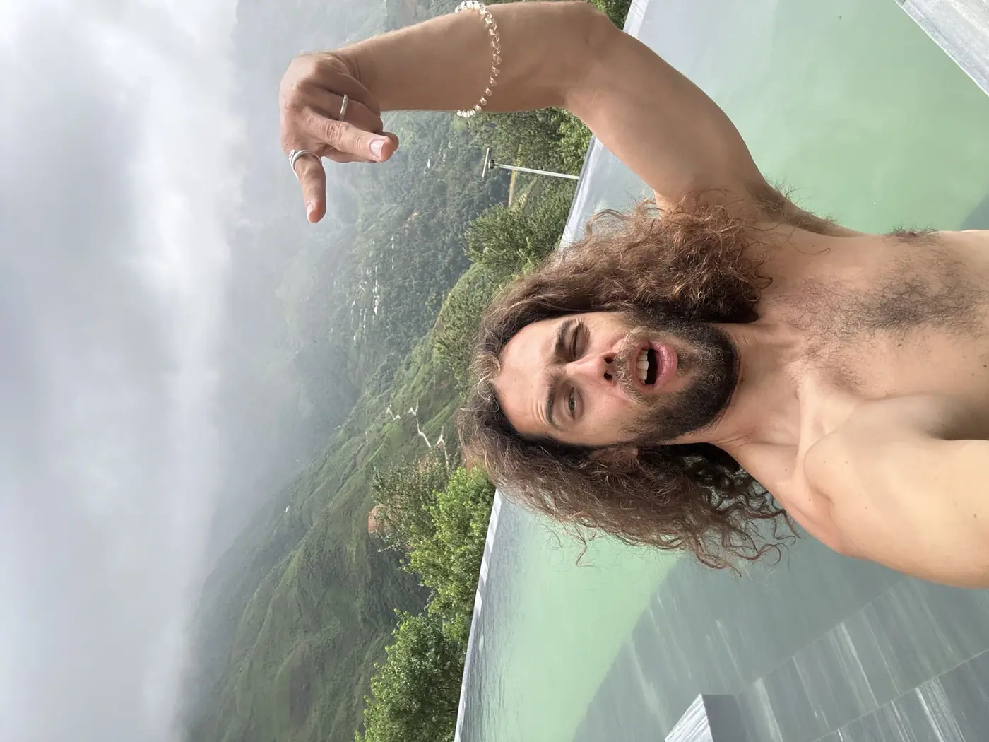 Traveler at an infinity pool overlooking cloud-covered Sapa mountains