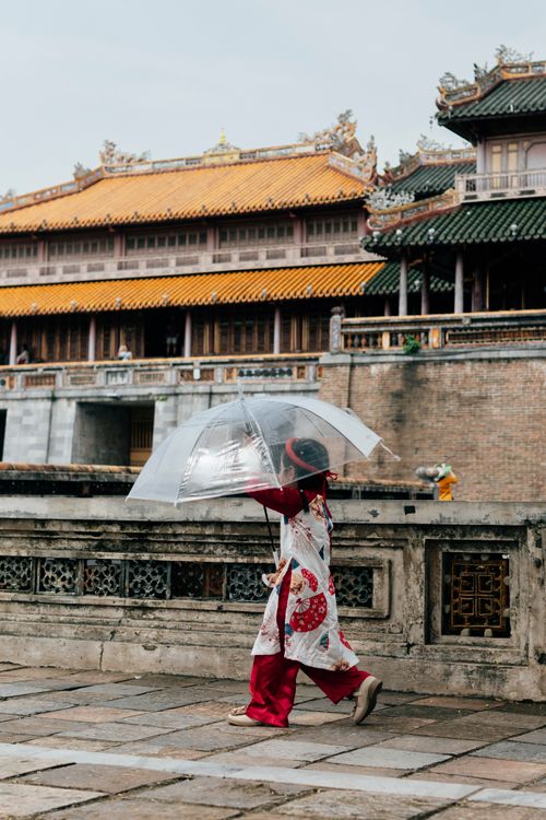 Visitors in traditional ao dai at Hue Imperial City