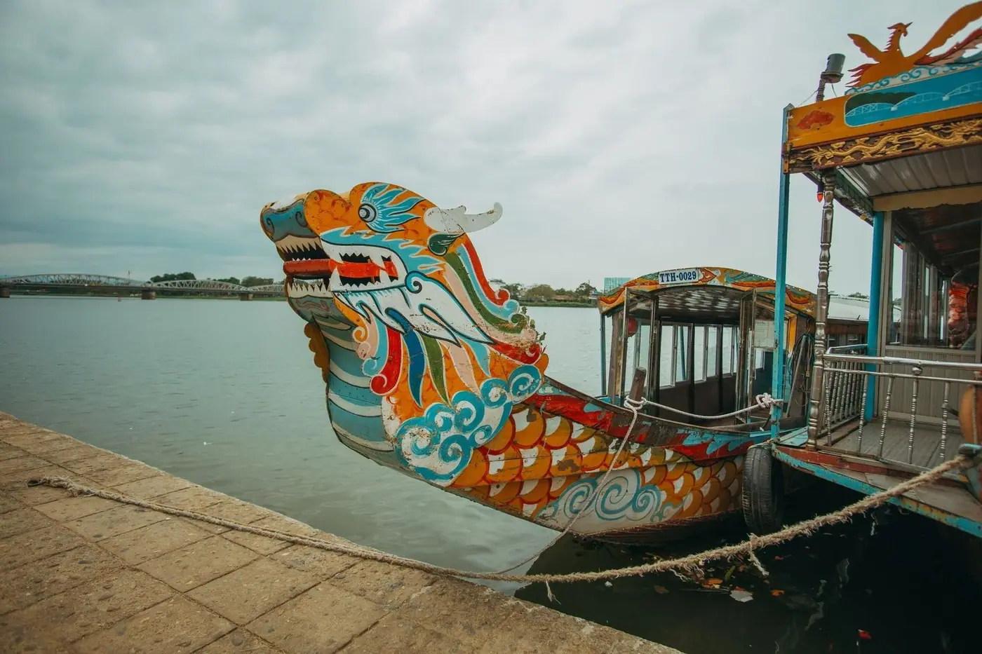 Traditional dragon boat docked on the Perfume River in Hue