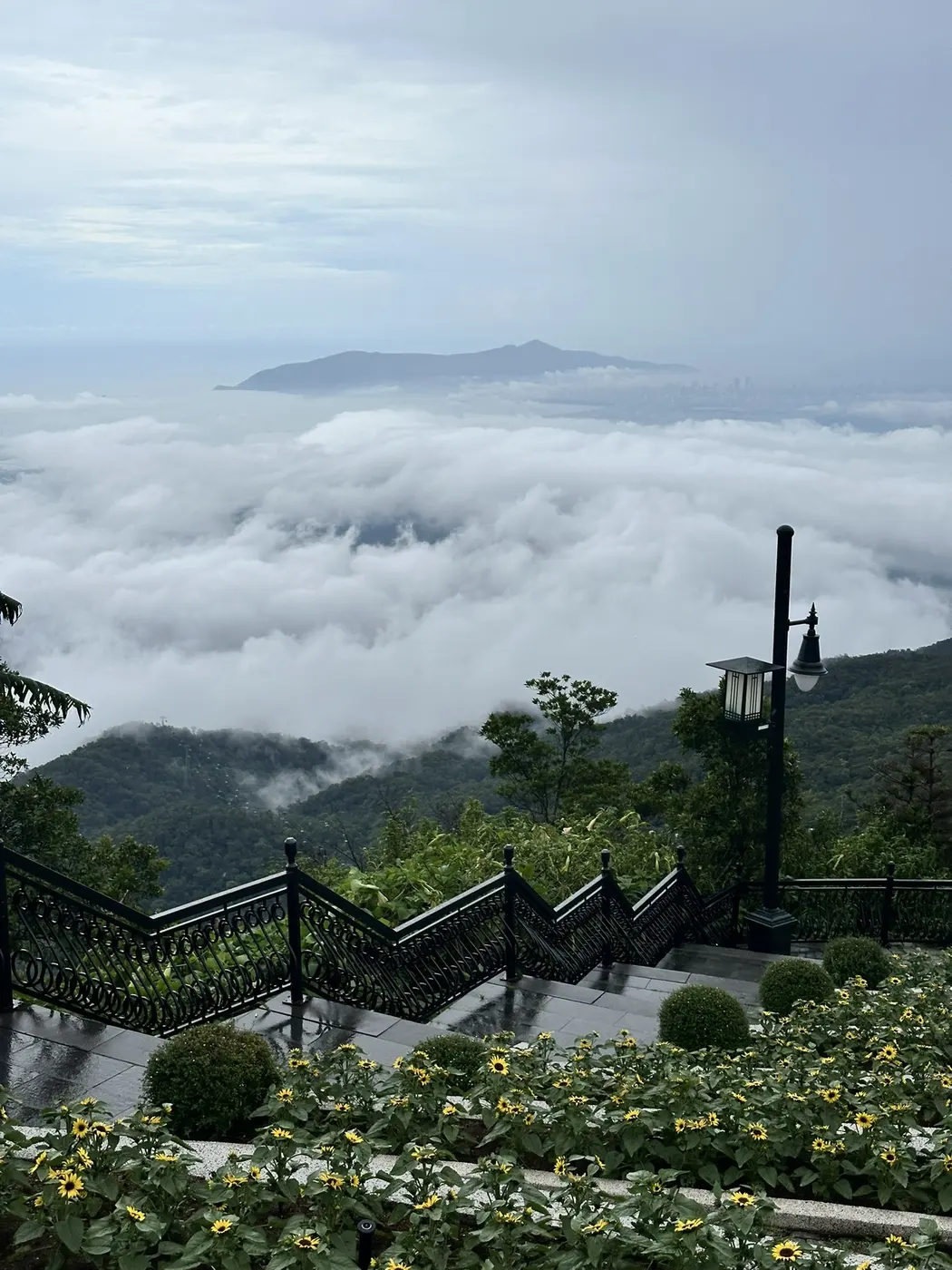 Stairs from the Ba Na Hills viewpoint descending into a sea of clouds above Da Nang