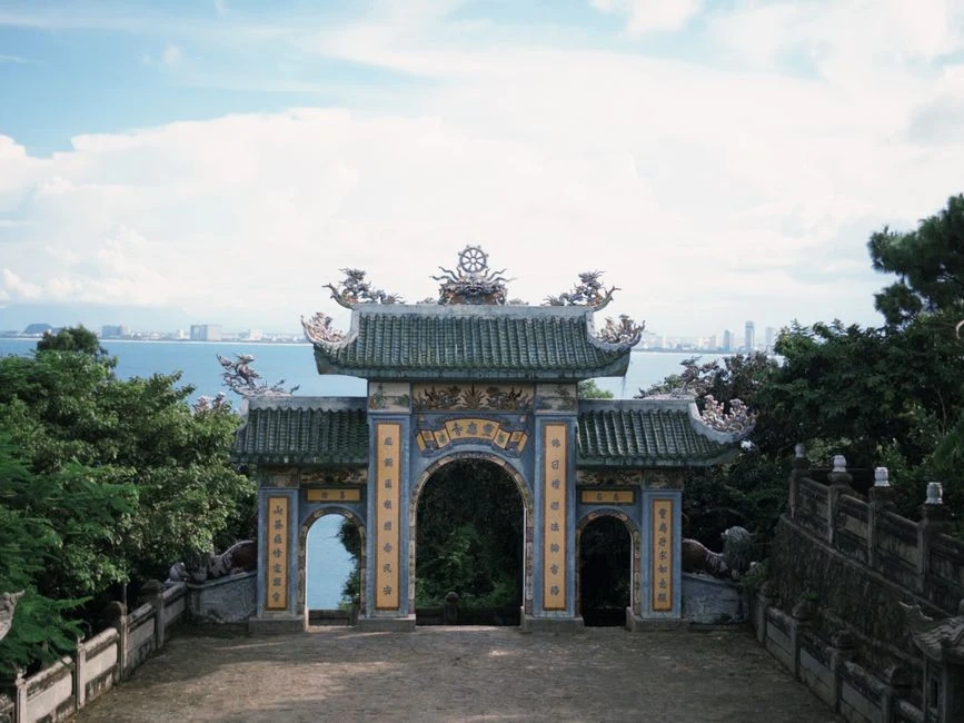 Linh Ung pagoda gate on Son Tra peninsula near Da Nang with the bay behind