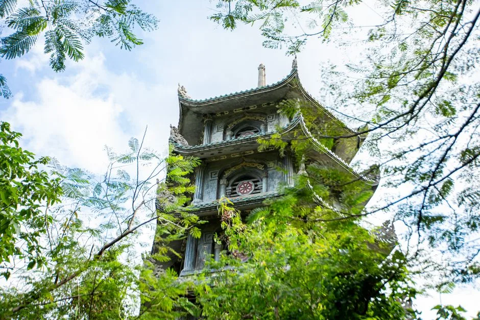 Stone pagoda tower among trees on Marble Mountains in Da Nang