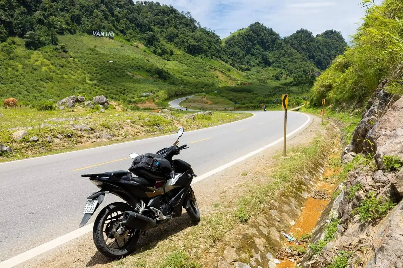 Motorbike parked on a winding mountain pass road in Vietnam