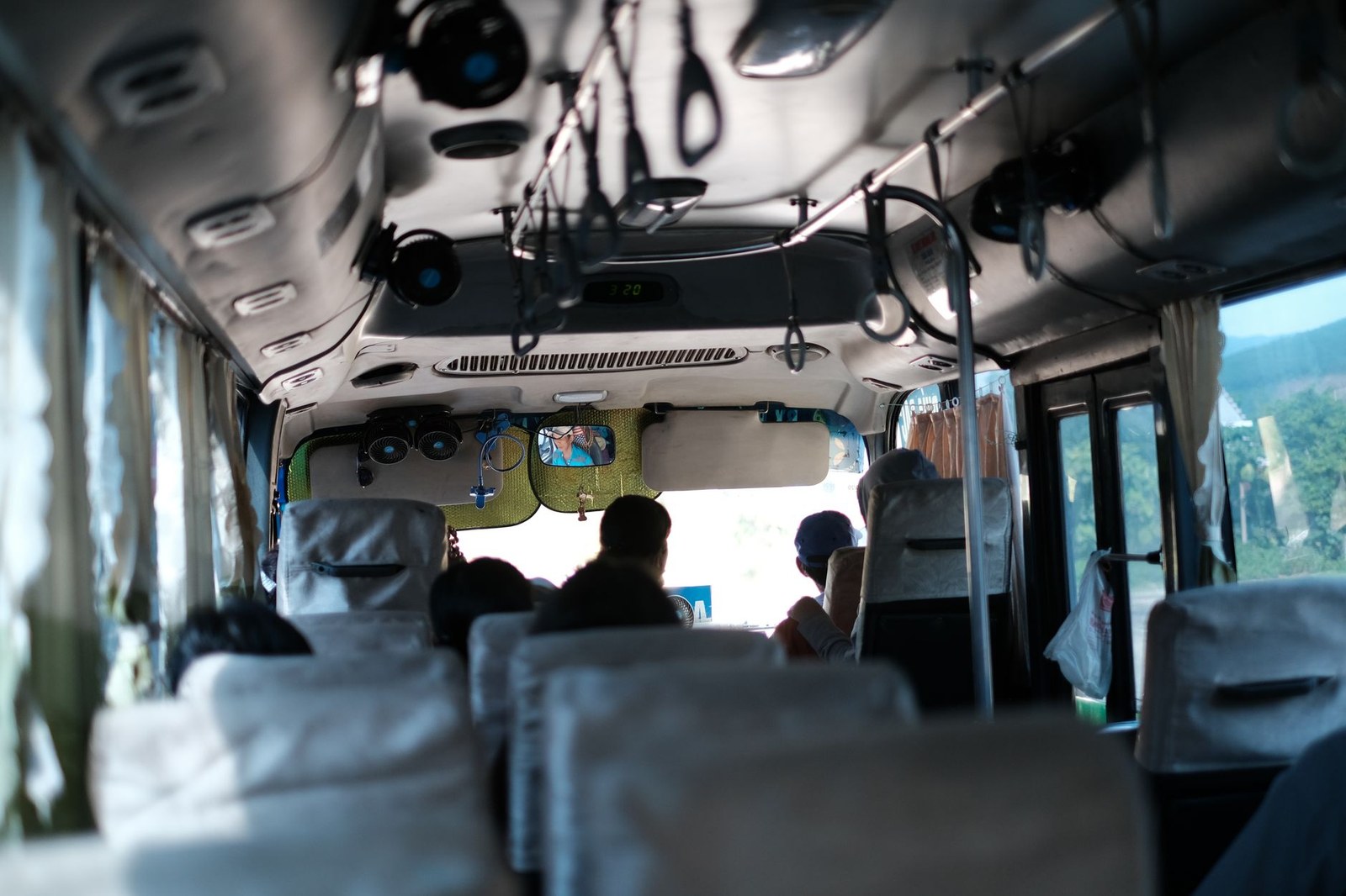 Interior view of a public bus traveling through the Vietnamese countryside