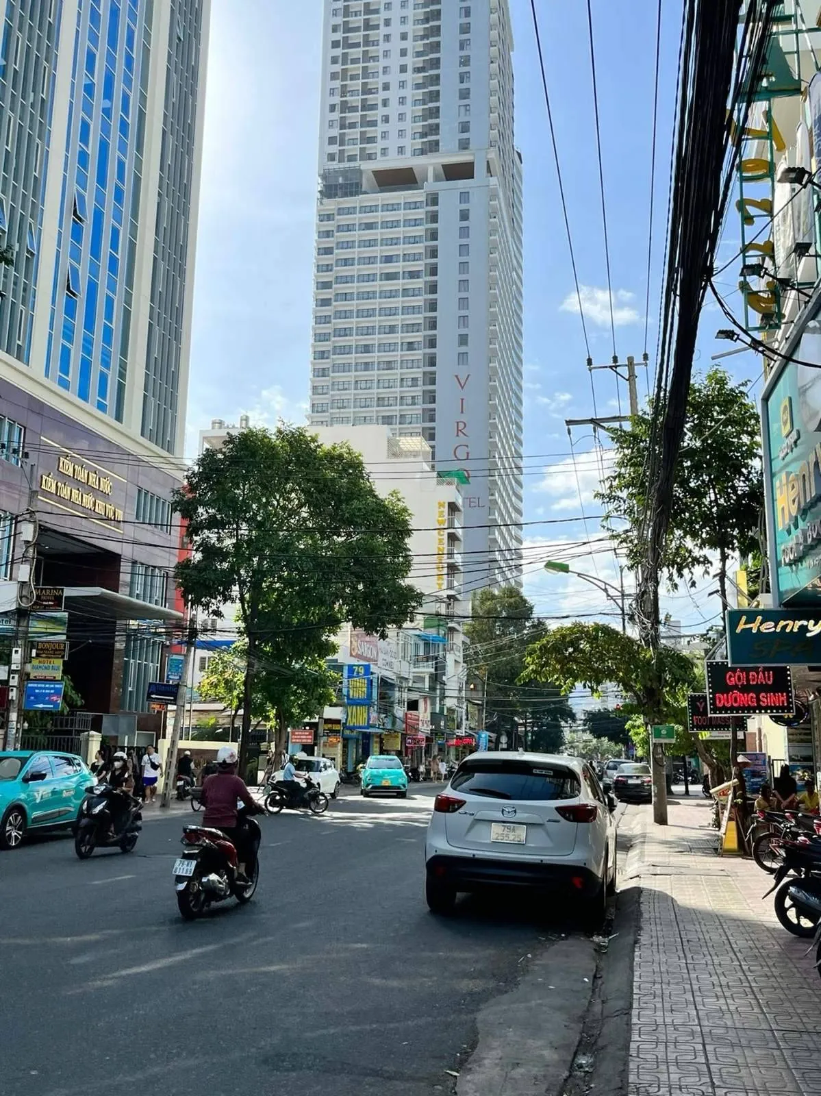 Street in central Nha Trang with the Virgo hotel tower and traffic