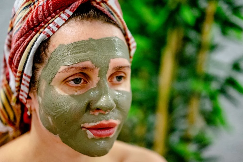 Face covered with grey clay during a mud treatment