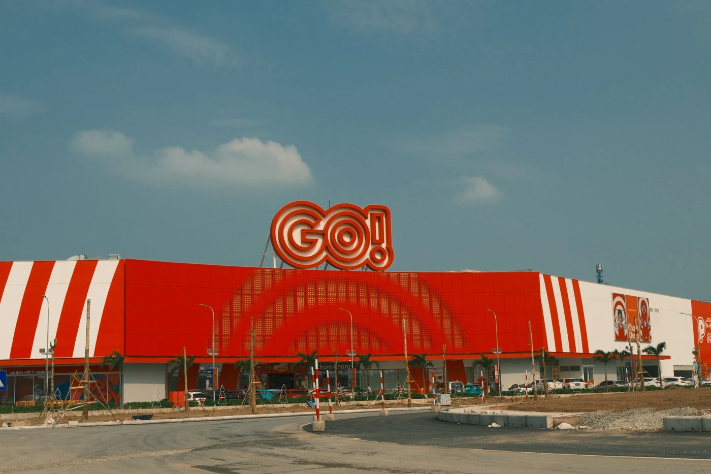 Orange and white GO! supermarket building under a blue sky