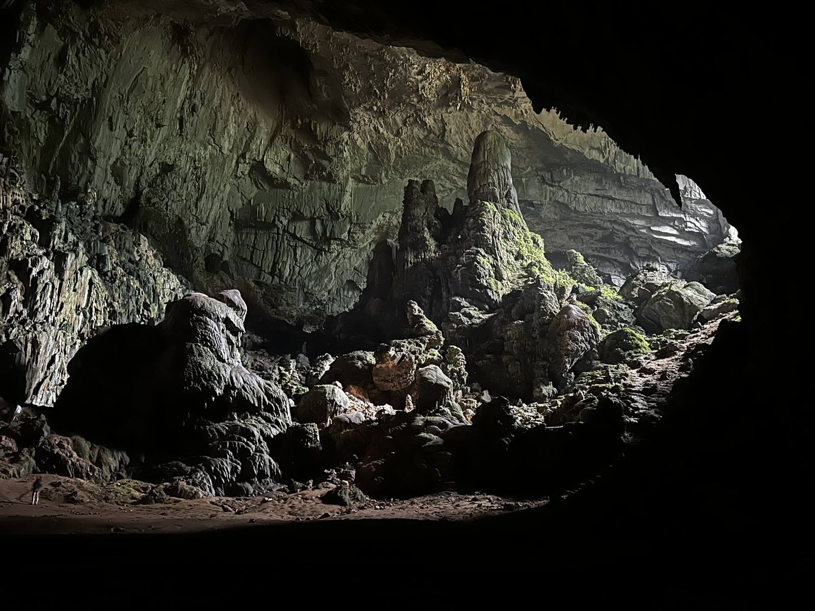 Wide limestone cave chamber lit from the entrance in Ninh Binh