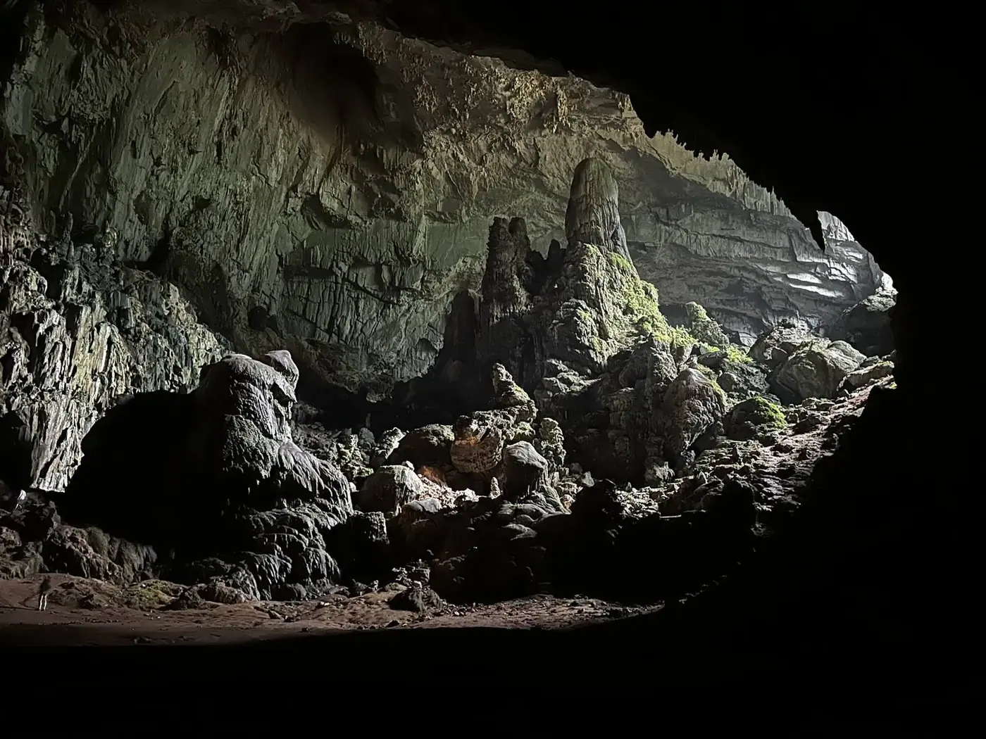 Wide limestone cave chamber lit from the entrance in Ninh Binh