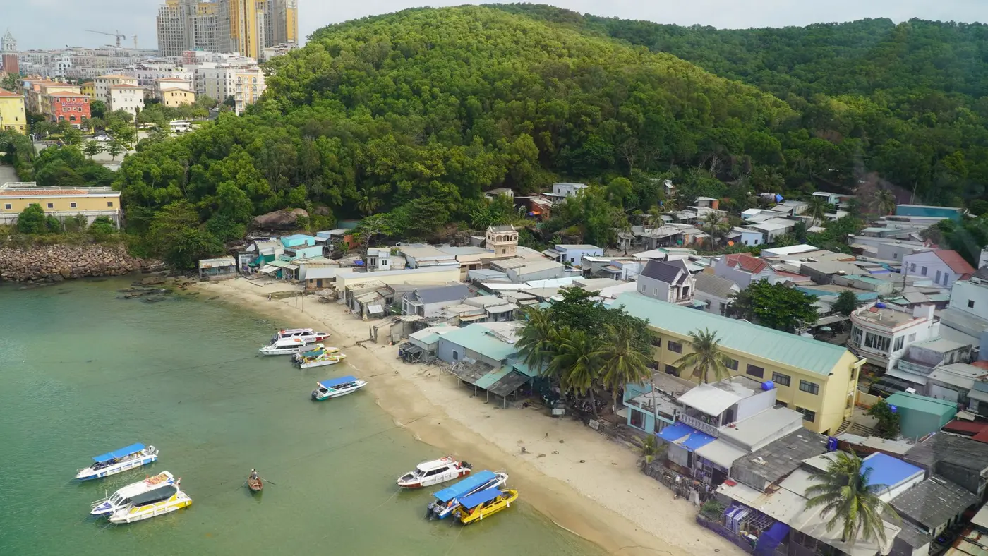 Fishing boats moored near a coastal village on Phu Quoc, seen from above