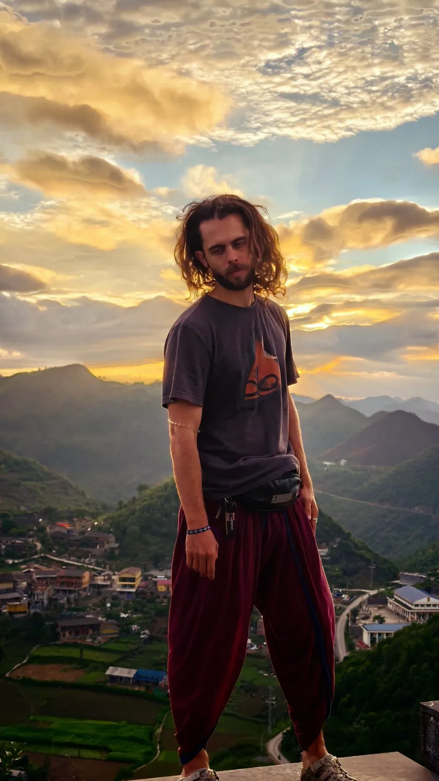 A traveler at sunset above the Ha Giang valley