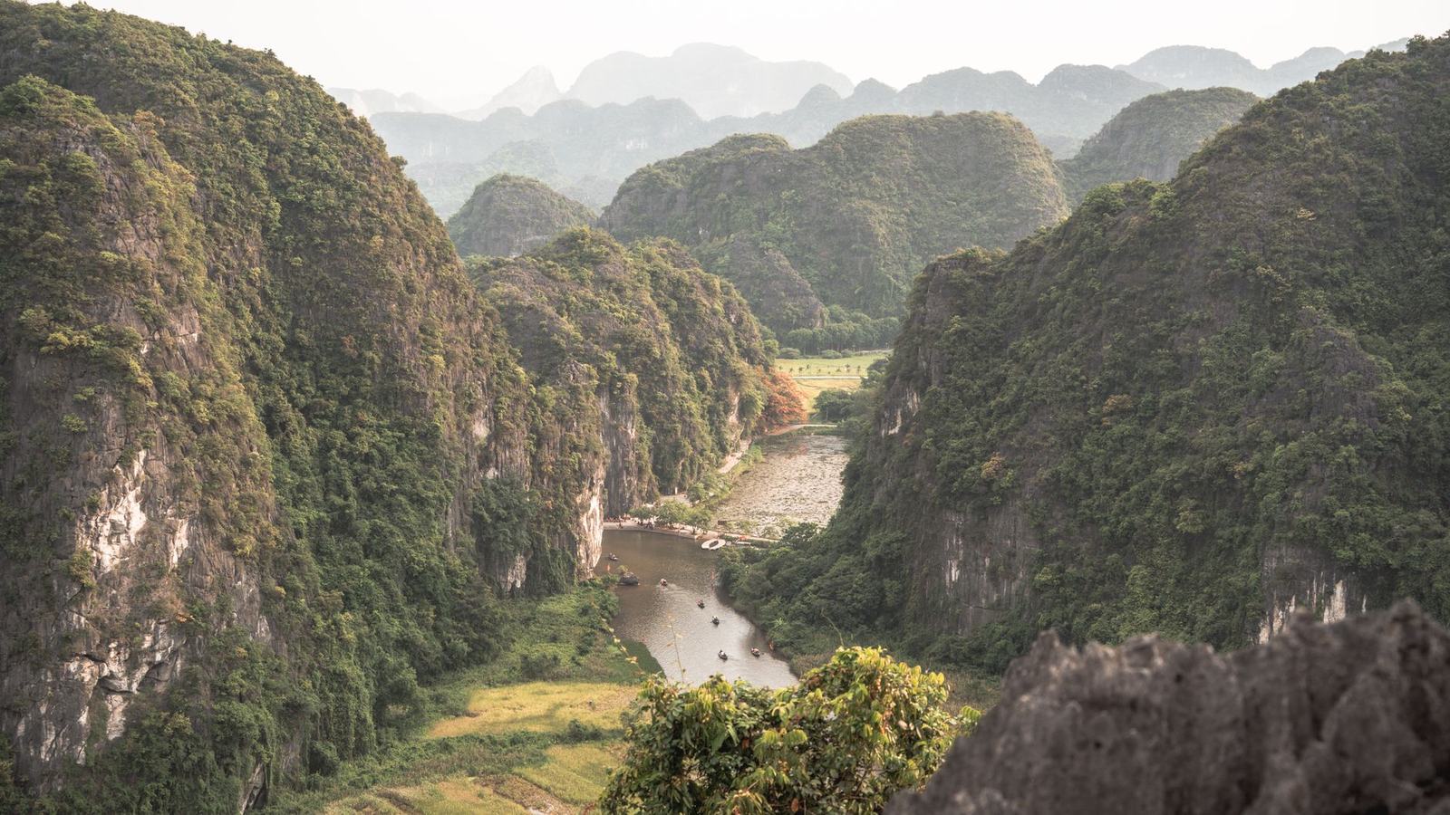 Aerial view of limestone karst mountains and a river valley in Vietnam