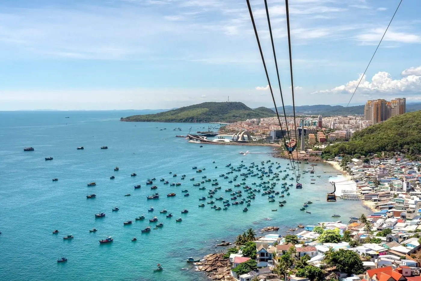 Cable car over fishing boats and turquoise water in southern Phu Quoc
