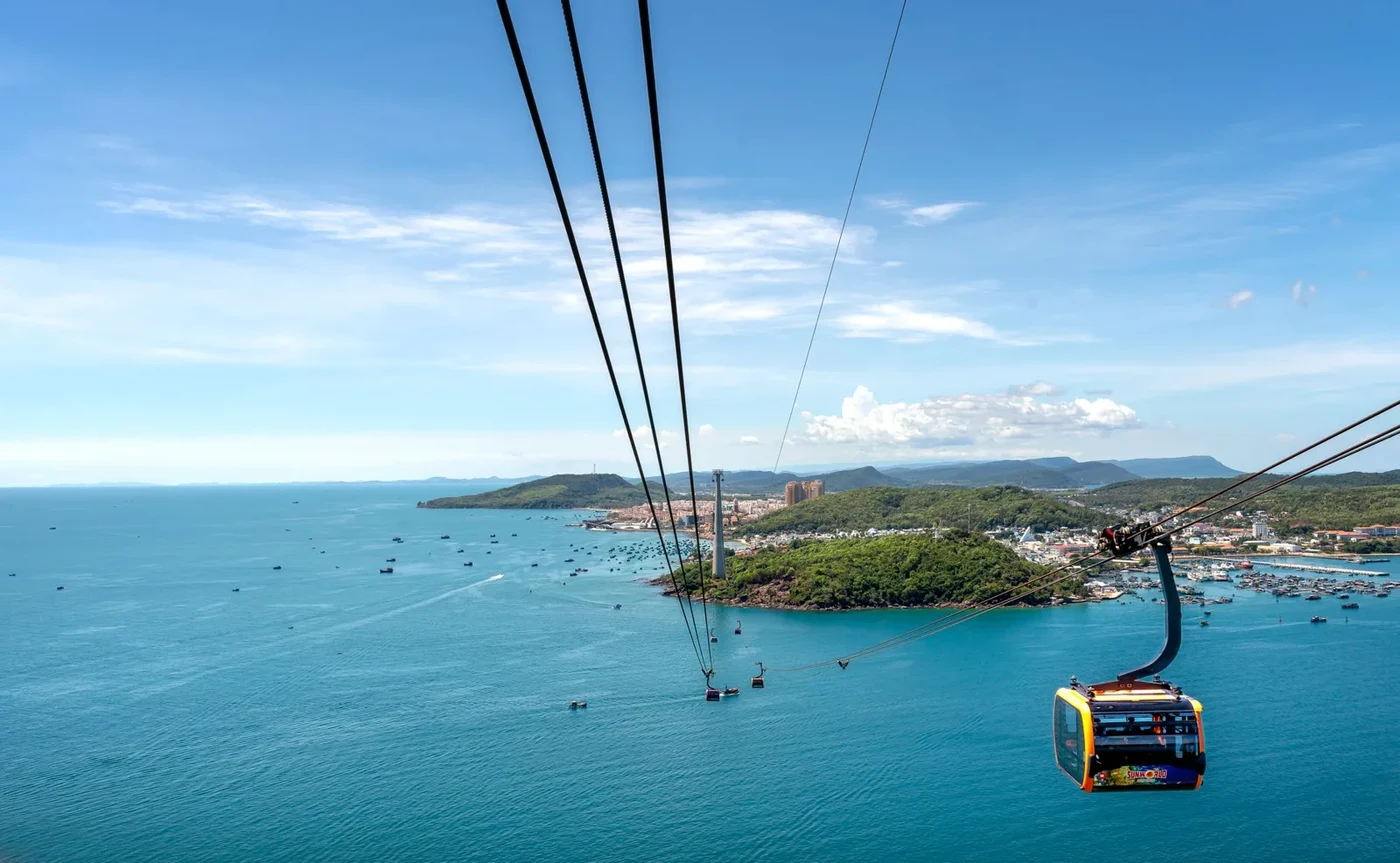 Cable car gondola above turquoise sea and small islands near Hon Thom