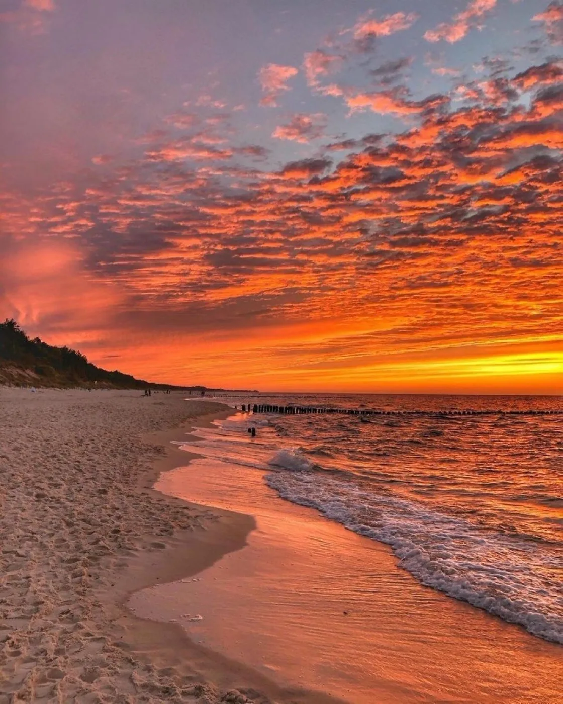Orange evening sky over a beach at low tide