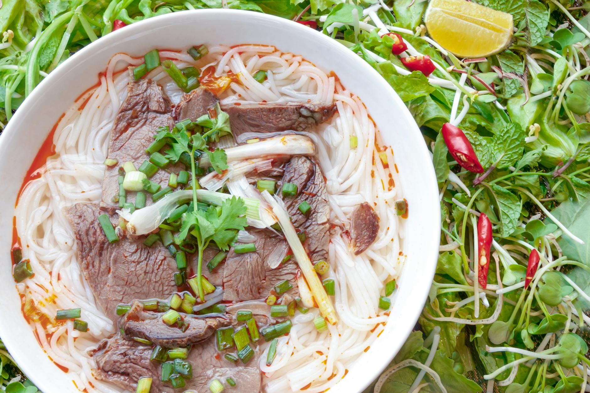 Bowl of Vietnamese pho noodle soup — daily food costs